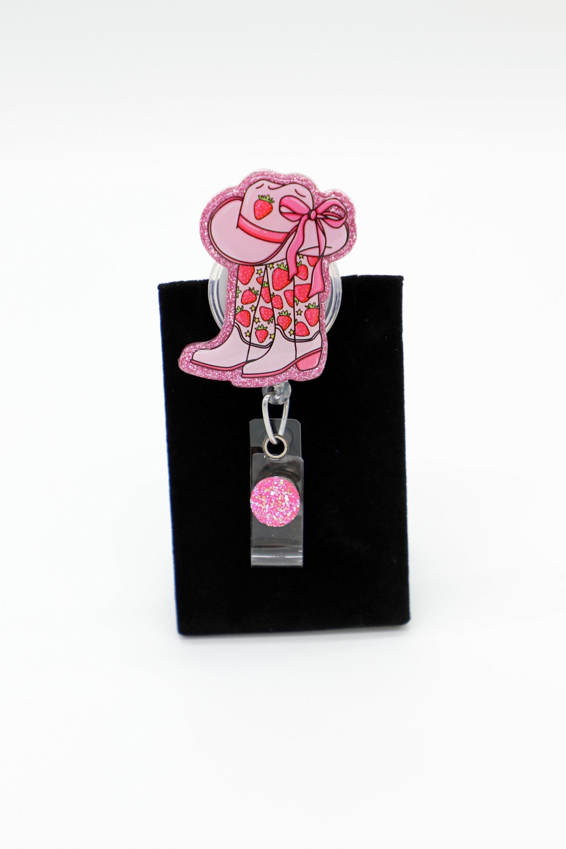 Pink Glitter Cowgirl Boot with strawberry and cowgirl hat acrylic that is mounted on clear badge reel.