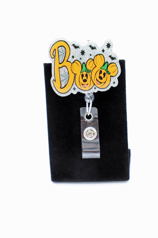 The bold “Boo” lettering sits on a shimmery silver backdrop with tiny bats and web details, giving your lanyard or pocket a festive, not-too-spooky shine. Designed as a mickey-inspired accent, it’s a fun pick for any Disney lover who wants subtle character vibes at work. The clear strap and smooth retractable pull keep your id holder easy to swipe, clip, and go without fuss. Perfect for a nurse, teacher, or anyone who needs an office id holder that still feels playful.